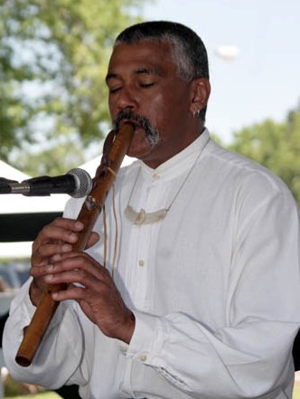 Hawk playing one of his flutes at a Cultural Survival event