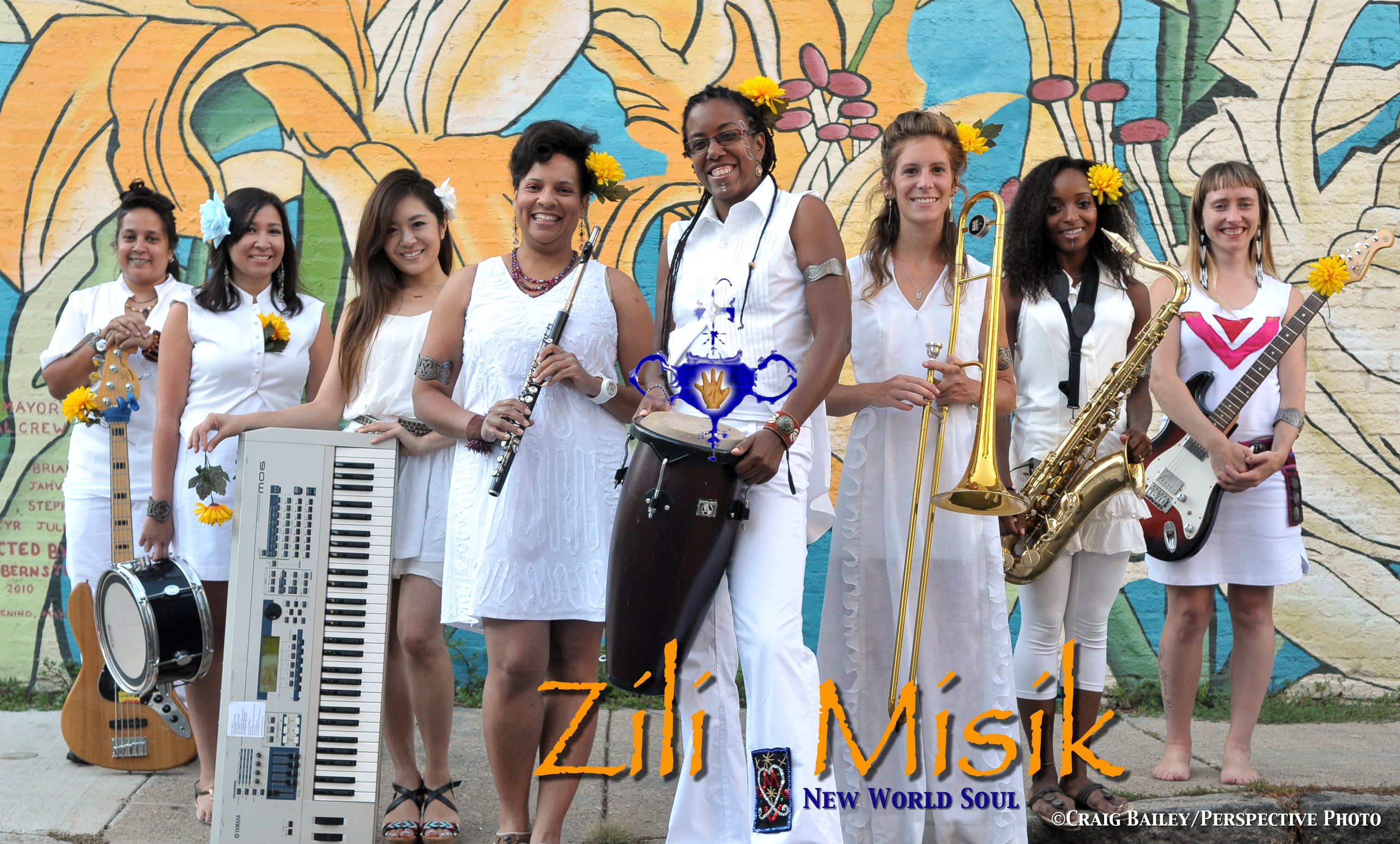 members of Zili Misik, holding instruments and smiling