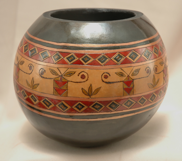 Bowl stands approximately five inches tall and is about 6' in diameter.  Ringed with tribal design.