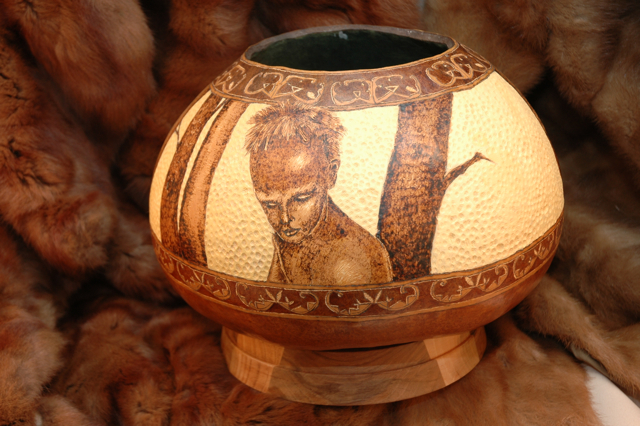 Bown stands about six inches tall and is approximately 7 inches in diameter.  Burned and textured.  Features the portraits of three warriors.