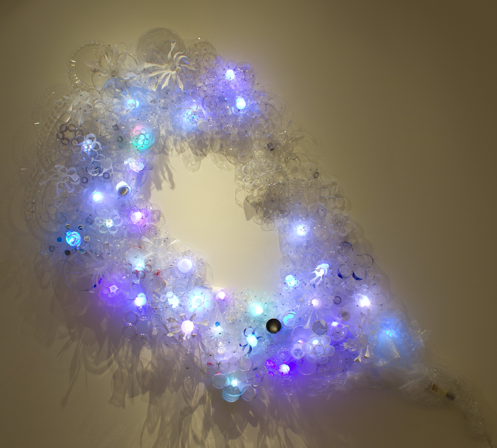 glowing sculpture made of post-consumer plastics in the shape of an ear, or amniotic fluid
