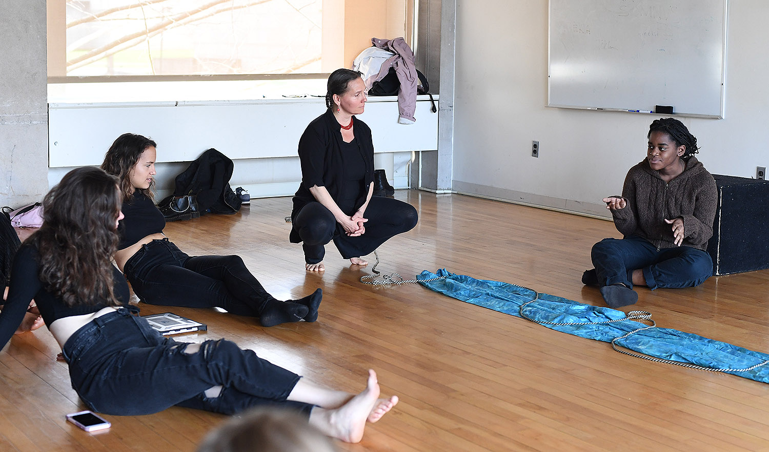 Marcella Trowbridge squatting while teaching
