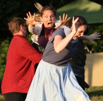 Woman playing Hermia flying through the air to attack Helena