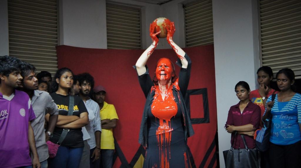 Woman pouring a bowl of blood over her head