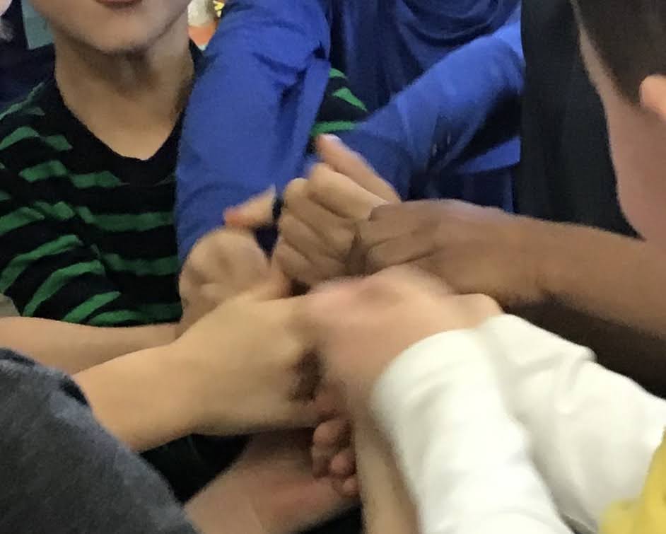 Classroom students at the Morse School holding hands as they unite creating a dance together during a Dance in the Schools classroom session. 
