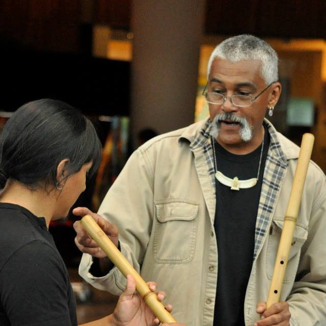 Hawk explaining how to play a flute