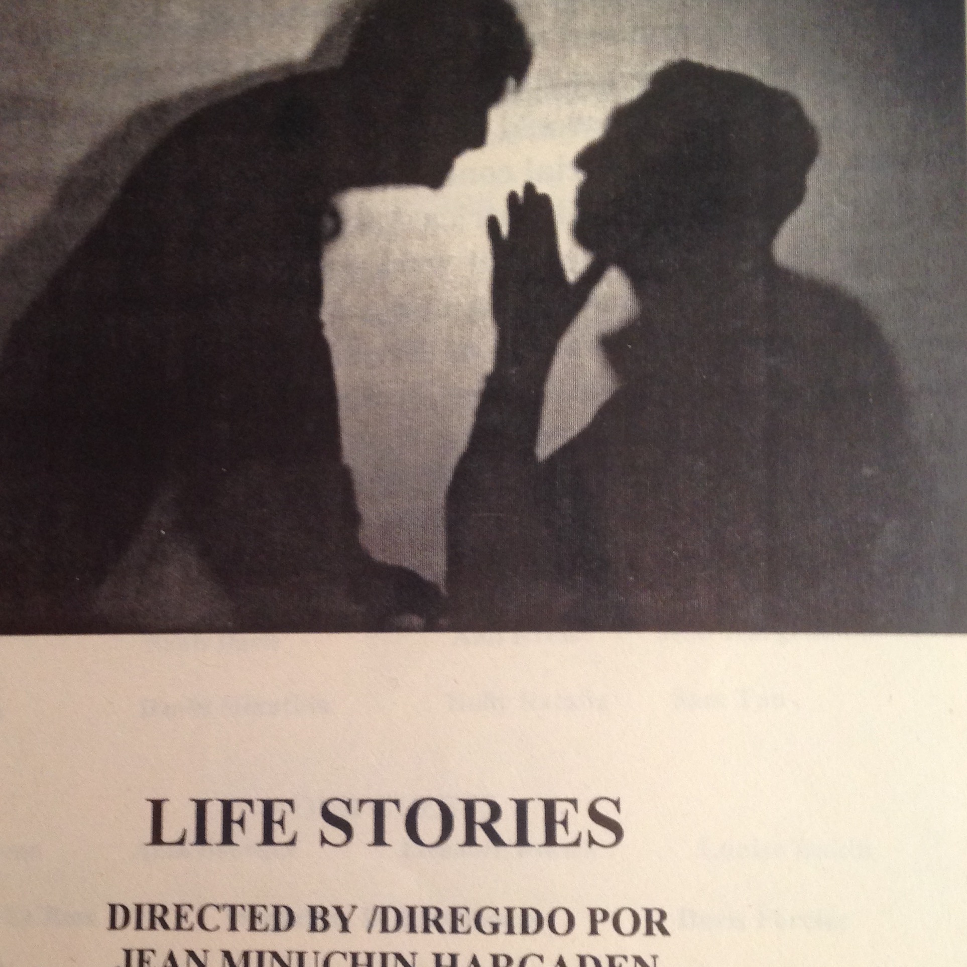 Shadow of a person whispering to another- Caption reads "Life Stories" which is the name of the play