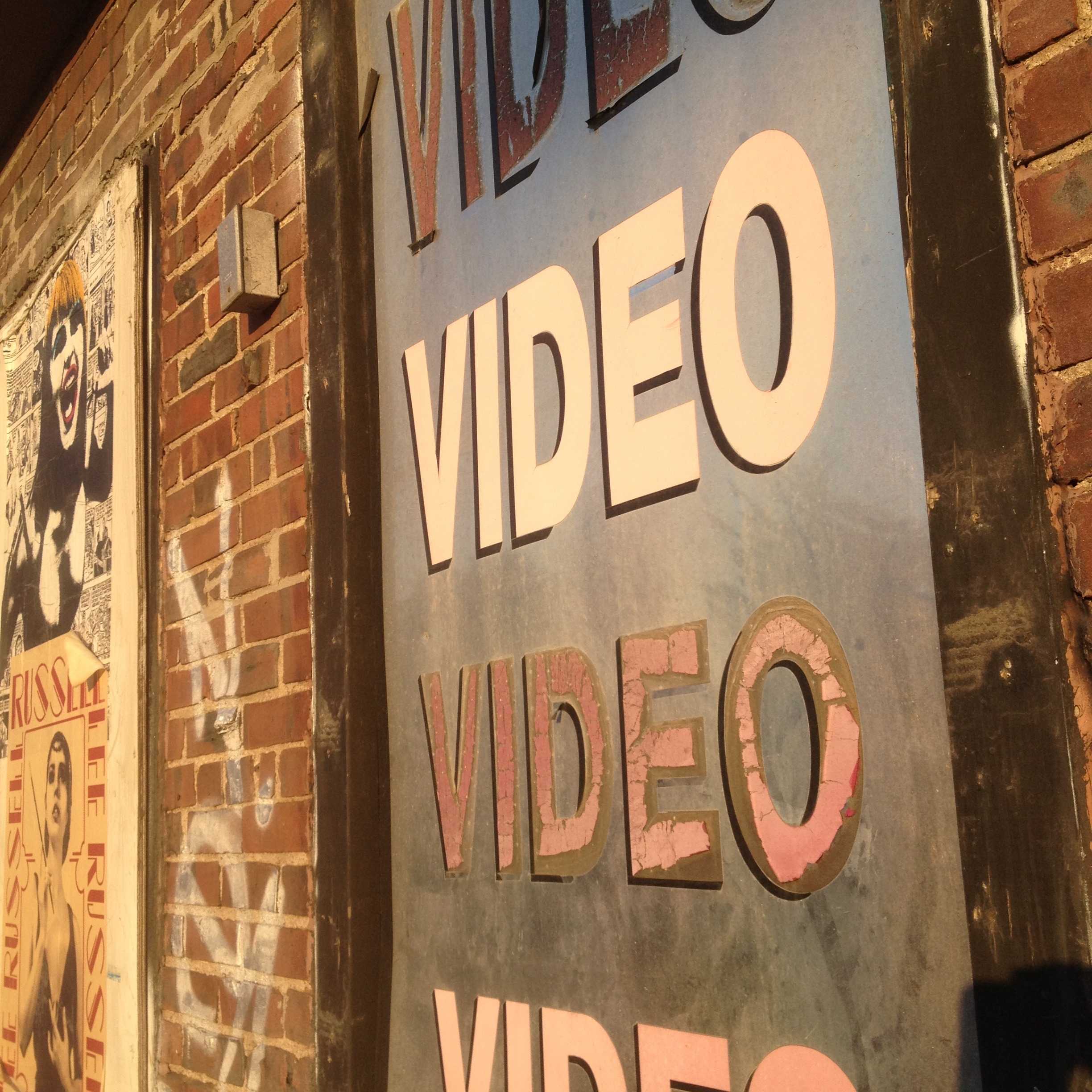 Multiple lines of the word Video on brick wall