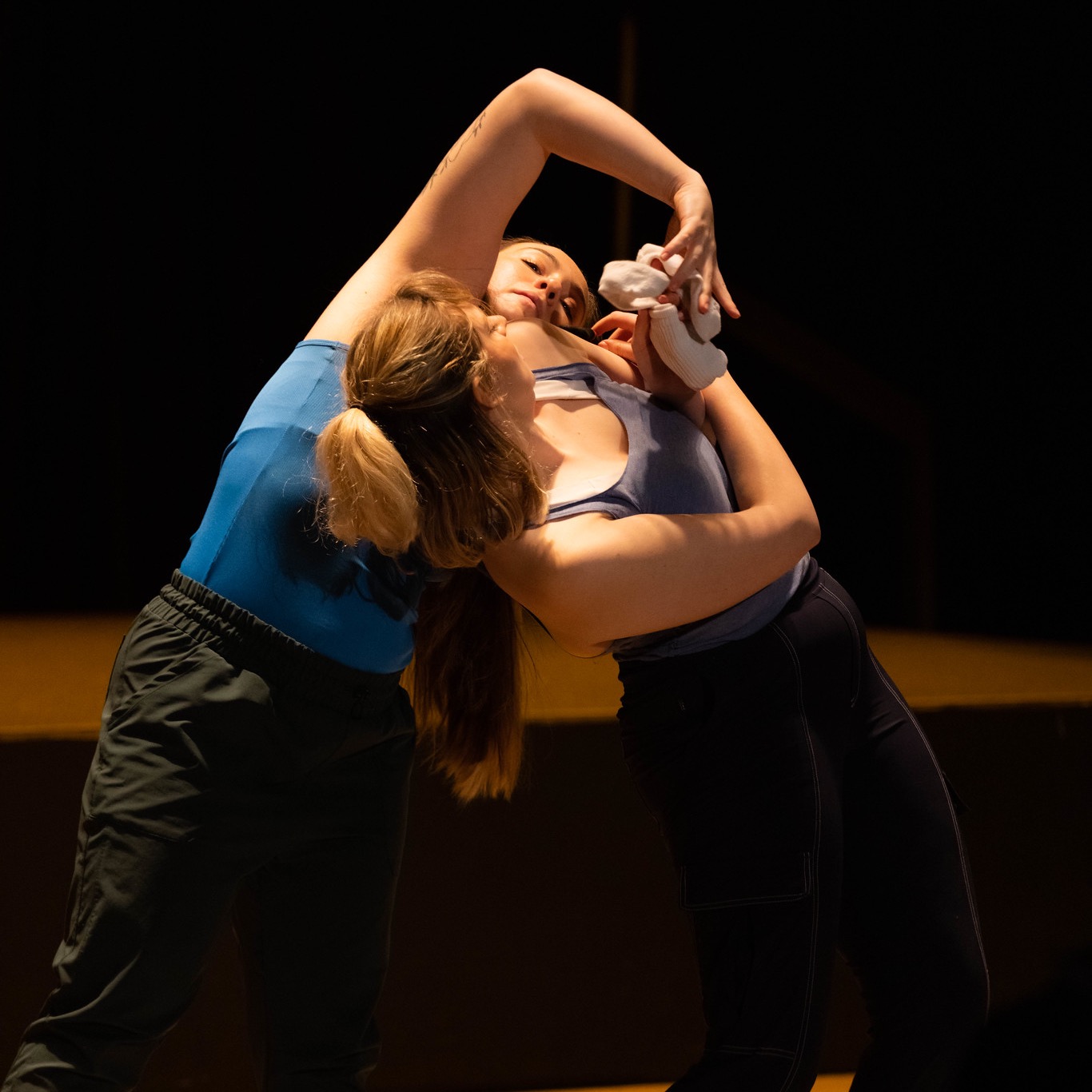 Two white women grappling over a pile of laundry