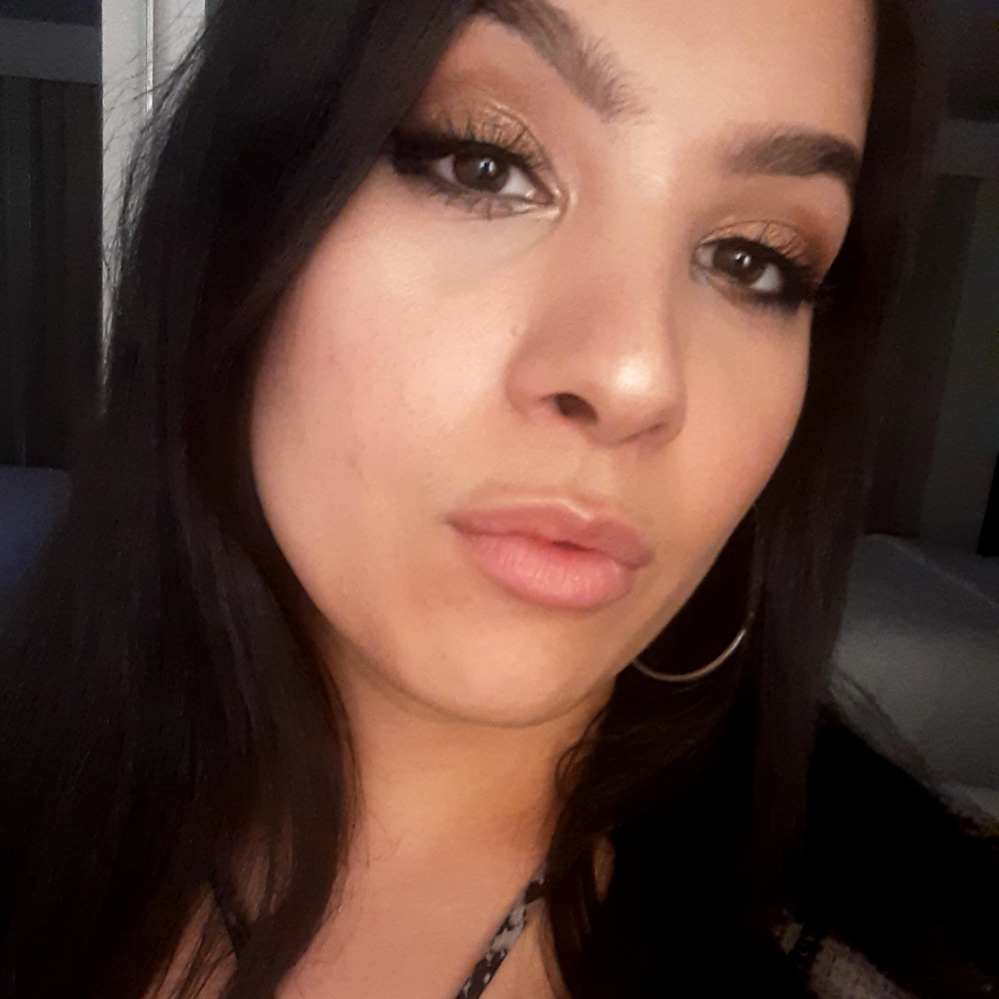 Headshot of a Latina women with black hair. 