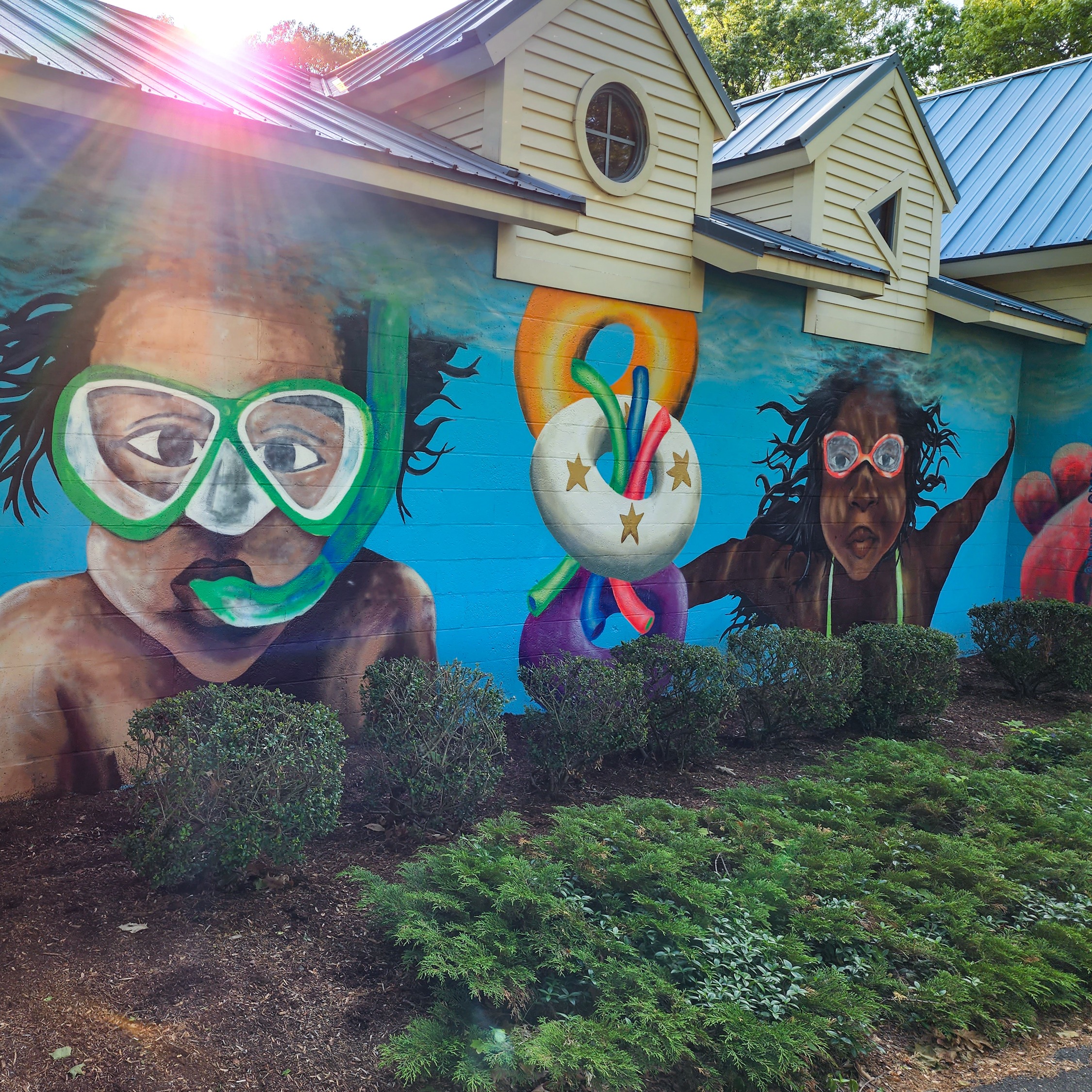Photo of mural depicting kids swimming under water