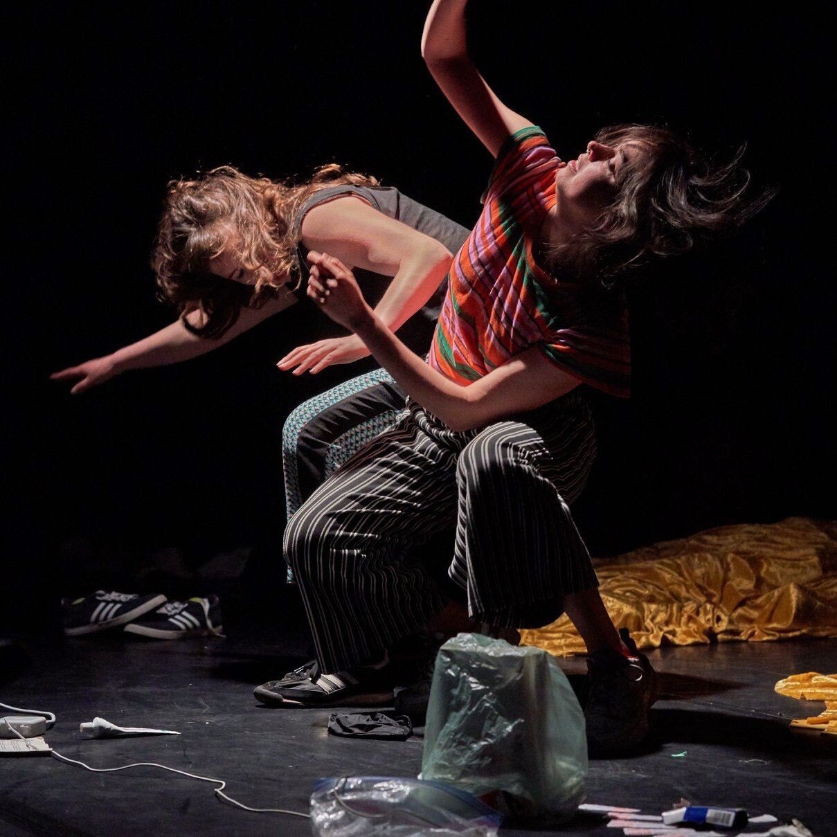 Two performers flail their arms 
