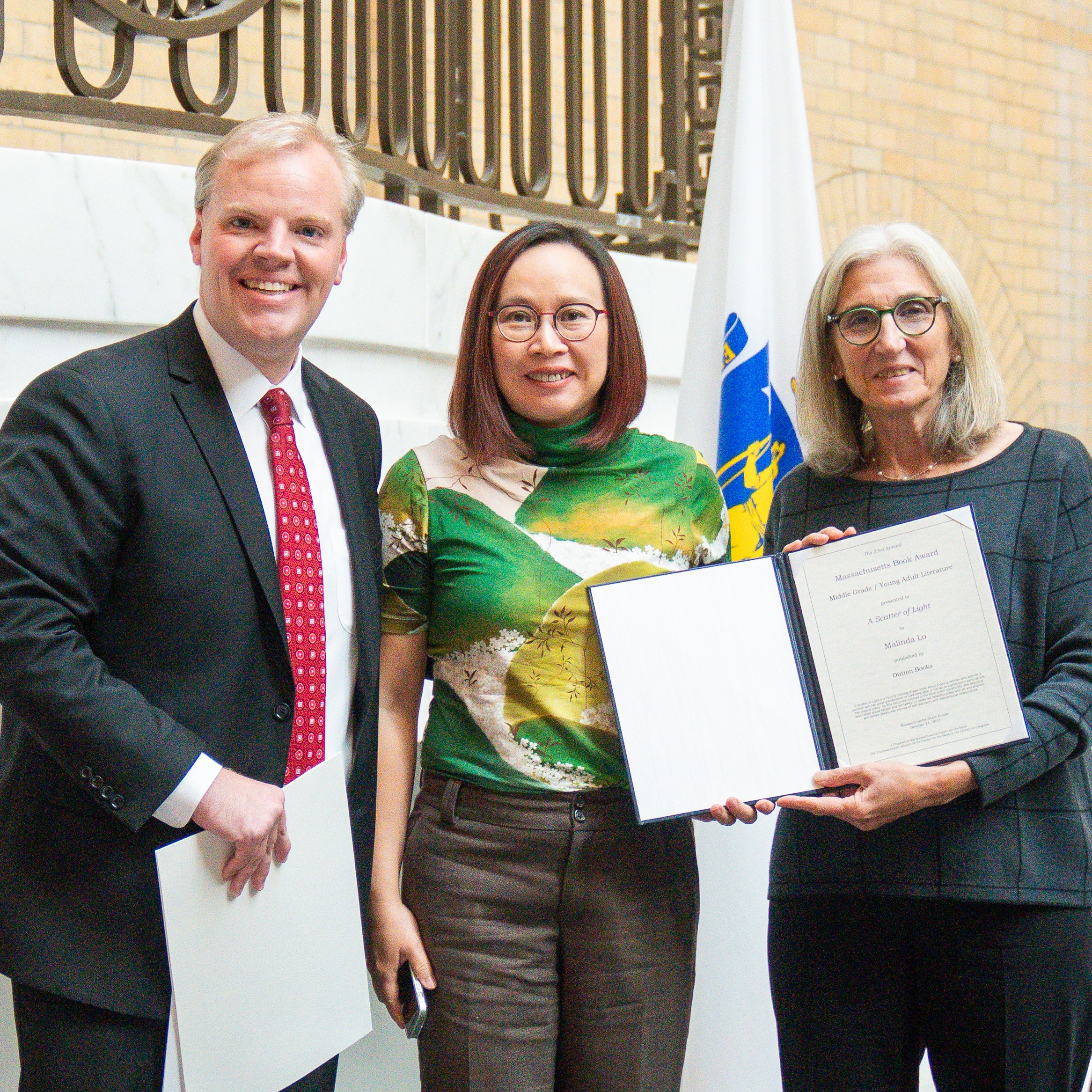 Author Malinda Lo accepts Award for her book A Scatter of Light at the Massachusetts Book Awards Ceremony