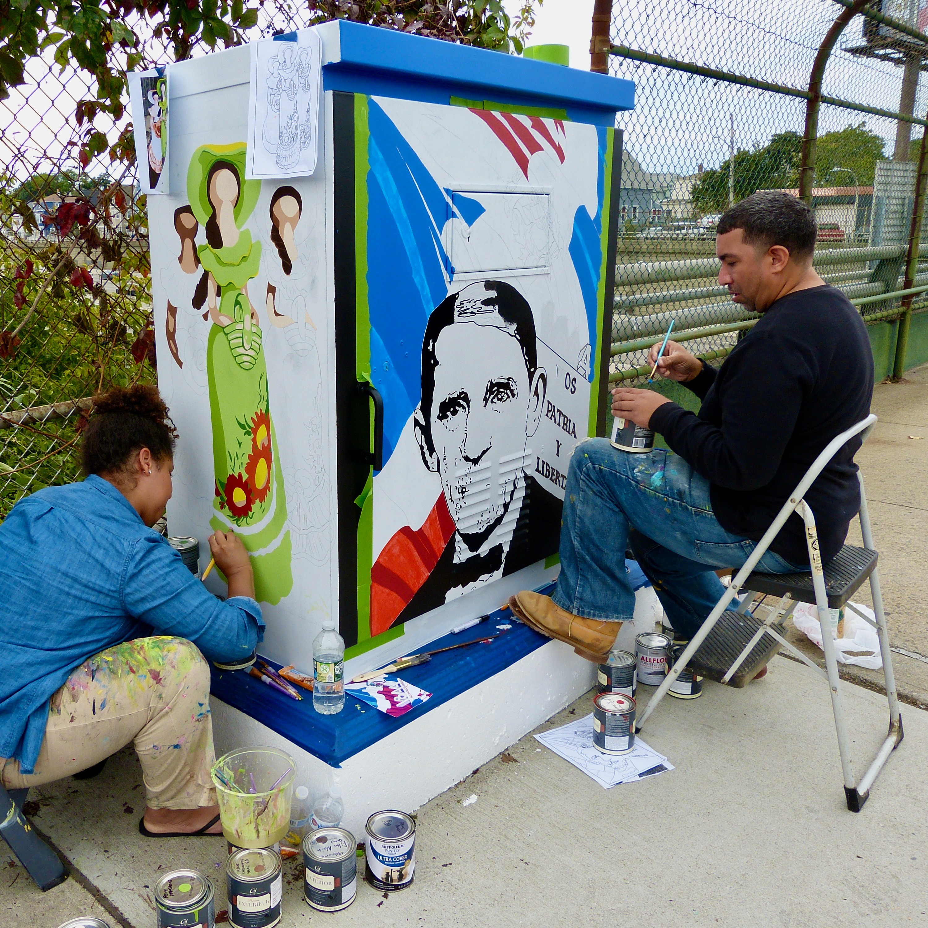 Artists-in-Residence creating a mural
