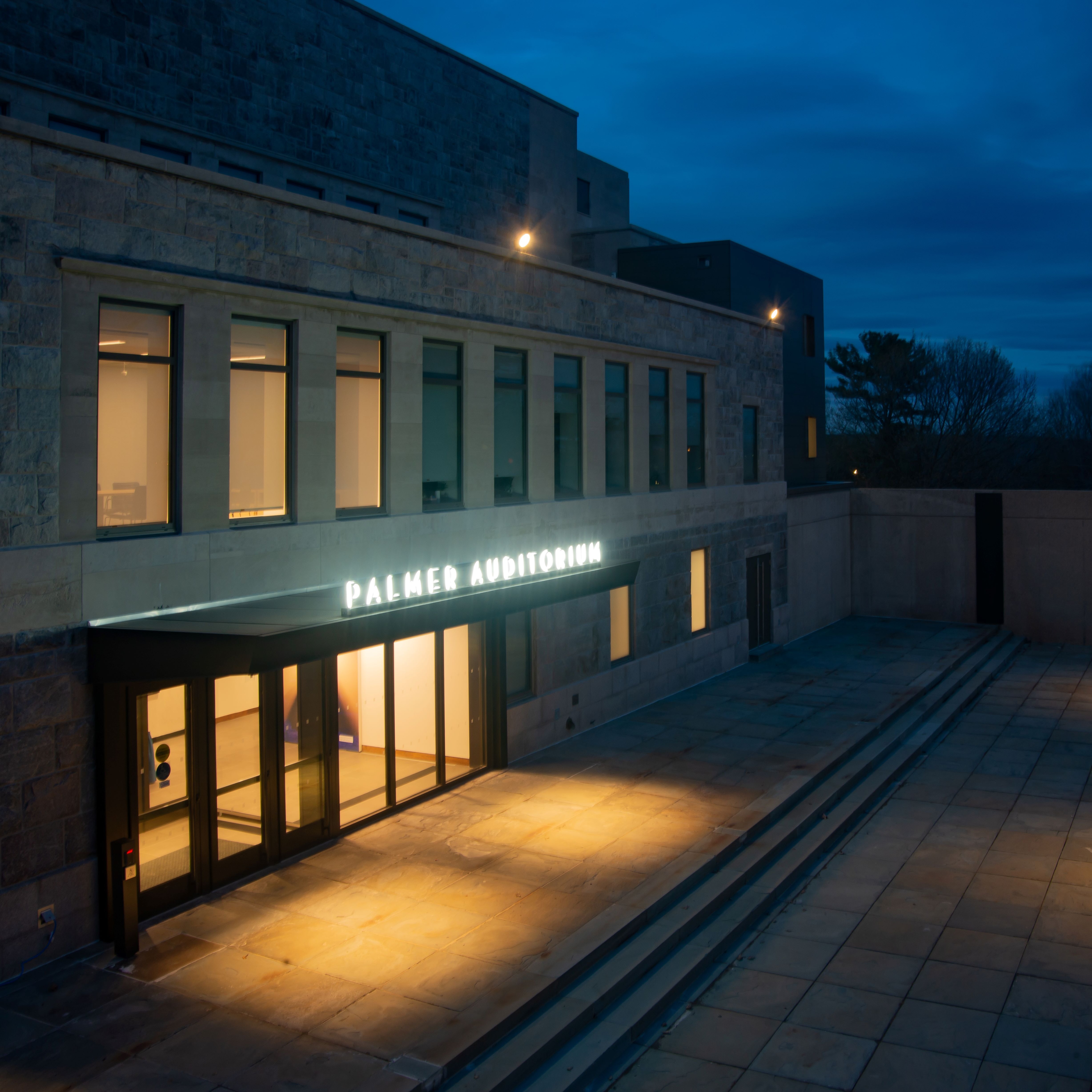 Night time view of the main entrance to Palmer Auditorium.