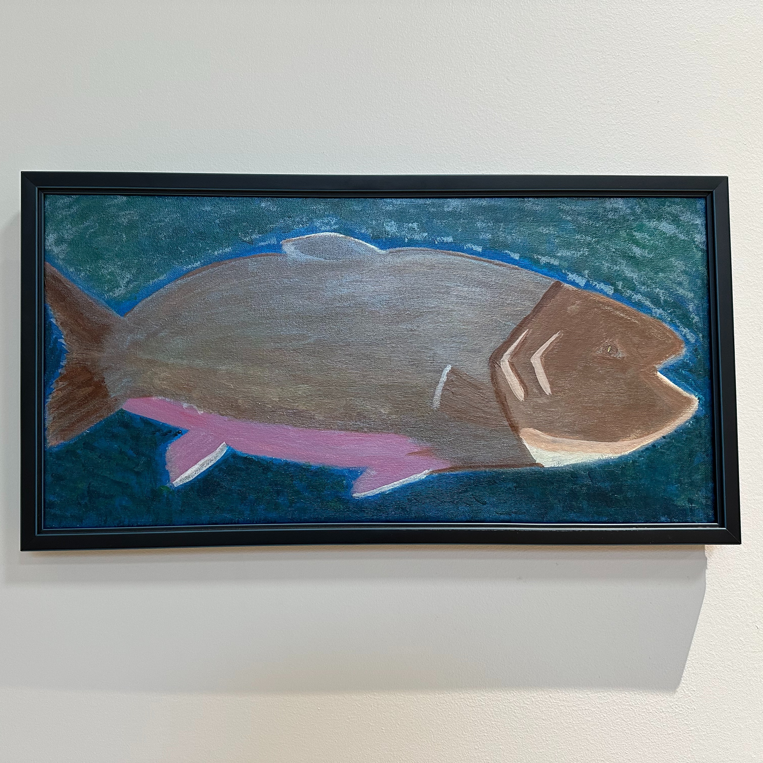 "Swimmy" an acrylic painting of a brook trout is framed. The fish is brown with a pinkish belly in dark green water. 