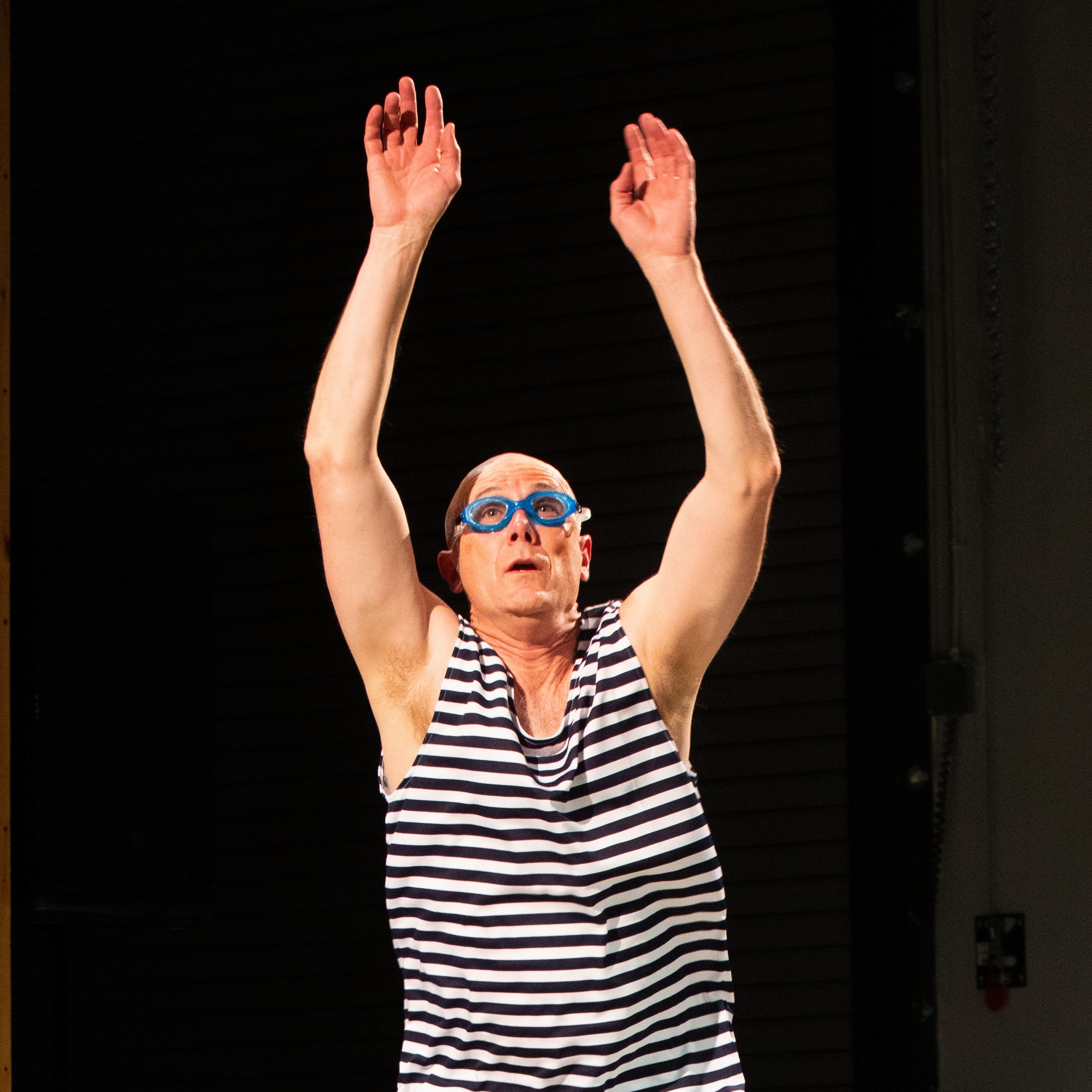 jumping man in vintage swimsuit and goggles