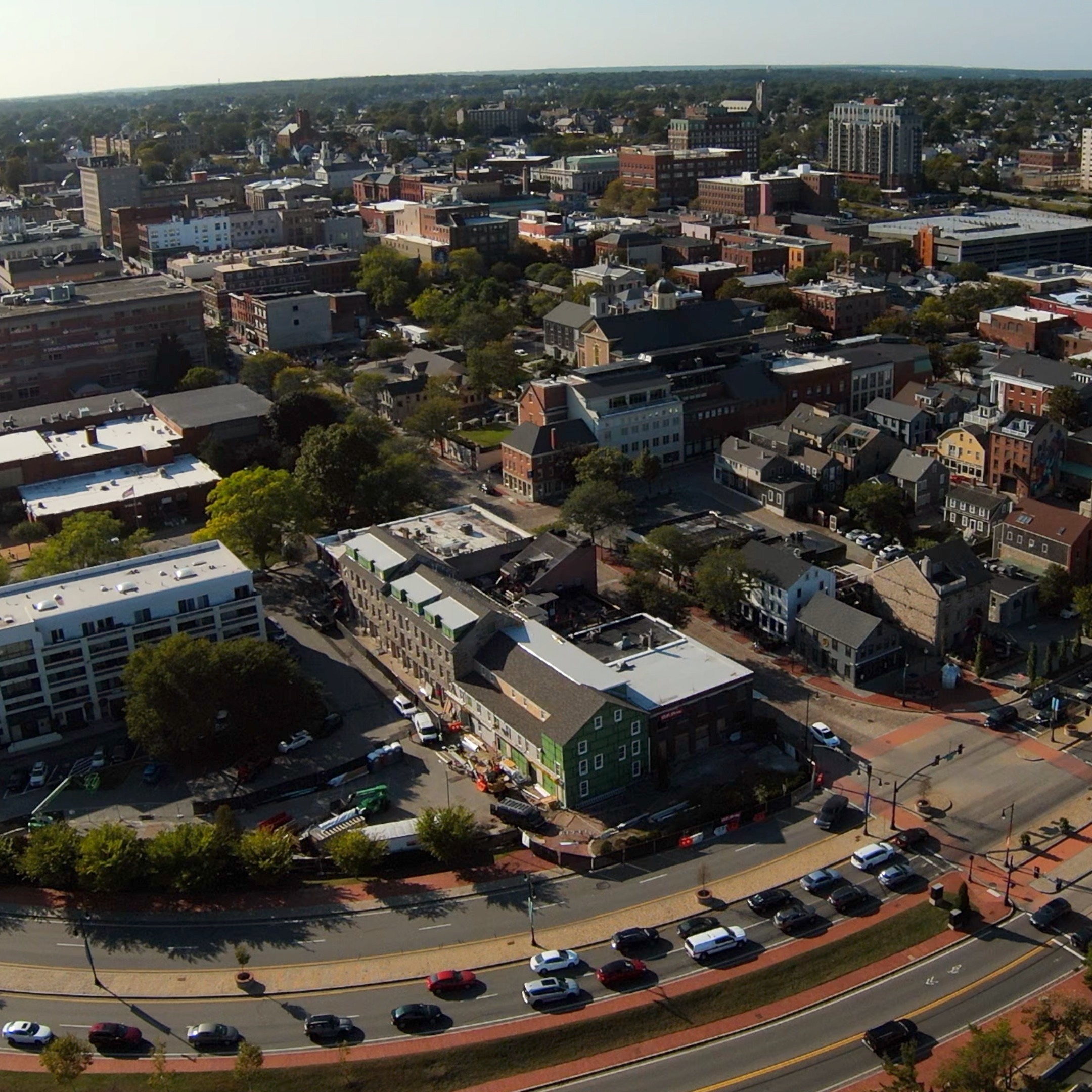 Drone photo of Seaport Cultural District looking Northwest featuring Route 18, several cars and buildings.