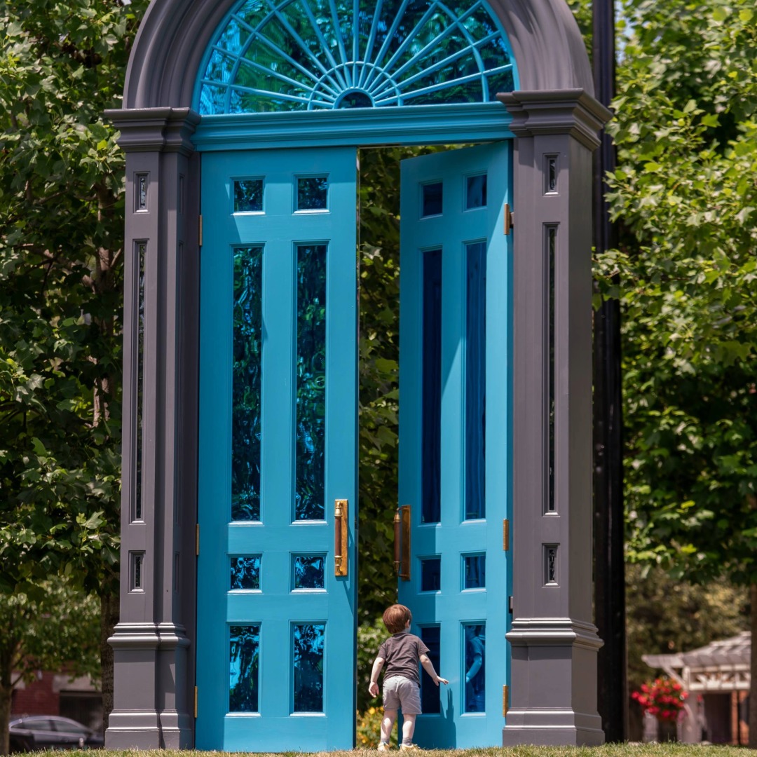 Photo of a child exploring Mark Reigelman's public art installation titled "Threshold"