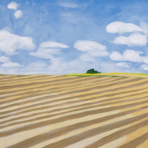 Landscape with spring furrows, blue sky and small windblown tree.