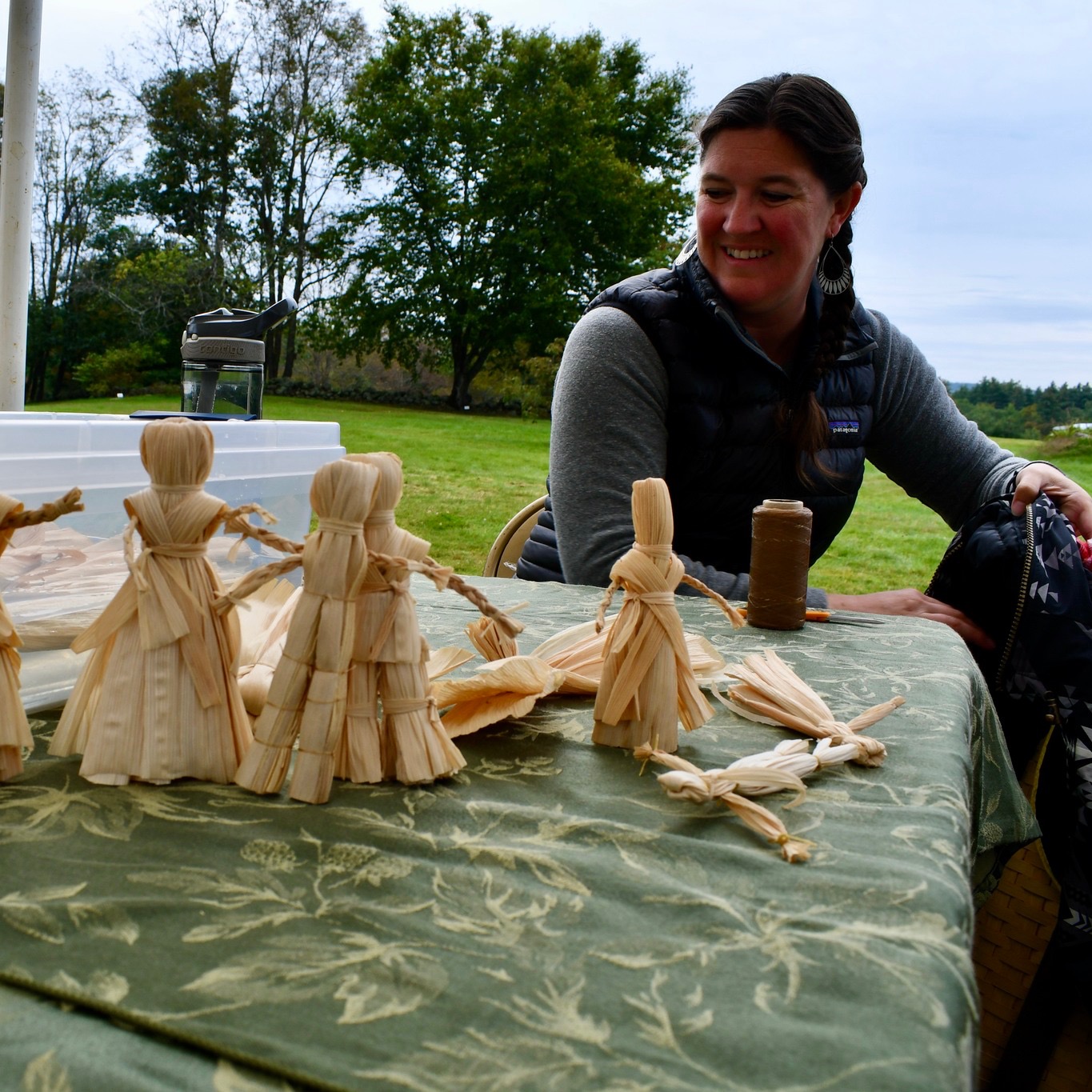 Native artist demonstrating cornhusk dolls