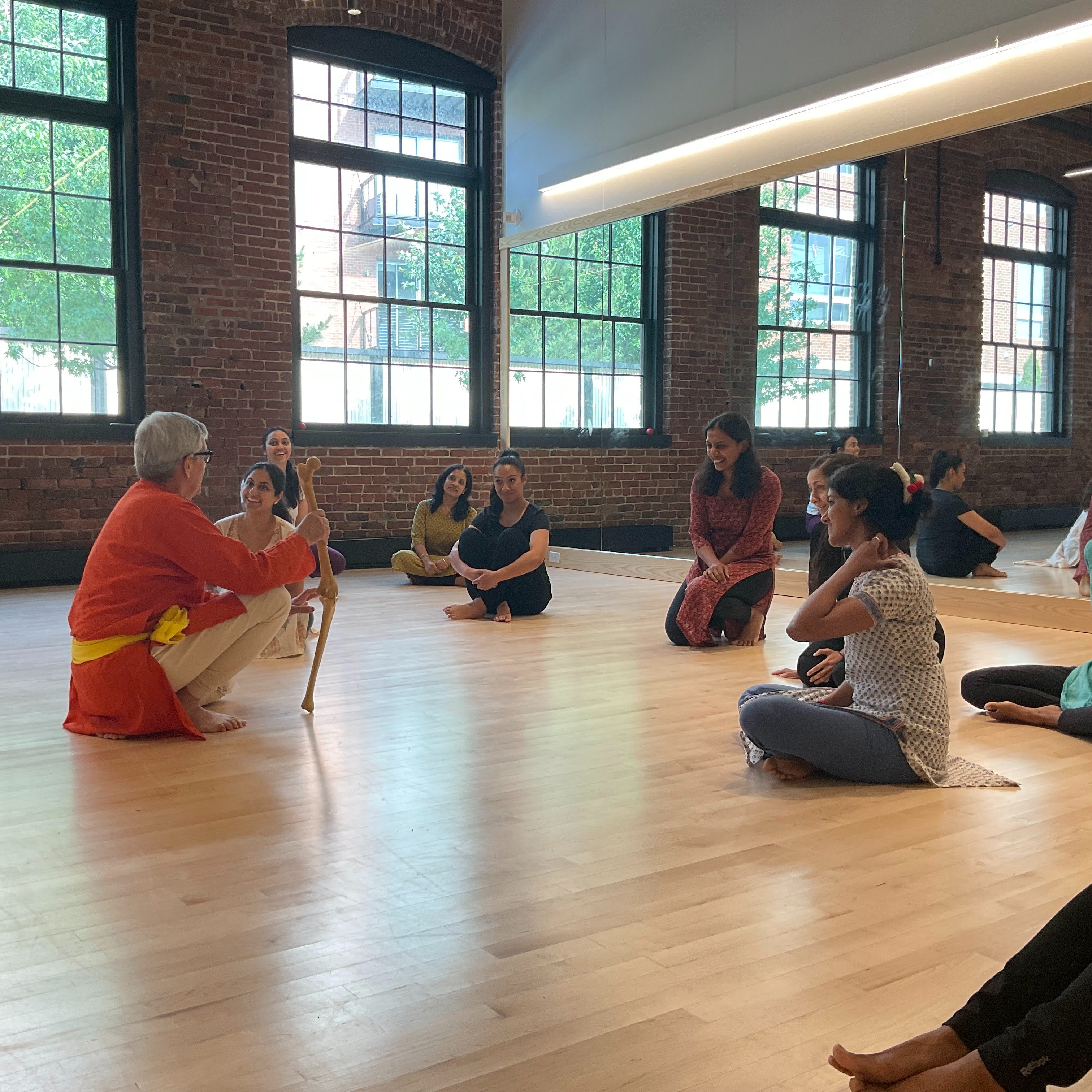 Dancers in a studio looking at a model of the human knee joint