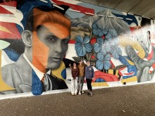 Muralist Brandon Marshall with his two assistants at "Passage" completed in 2025.