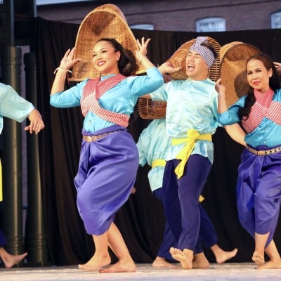 Angkor Dance Troupe's dancers performing a Khmer folk dance on stage at the Boarding House Park.