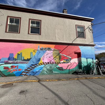 The town of Ayer's first mural, highlighting the history of transportation, Fort Devens, and the Indigenous grounds it was built upon.